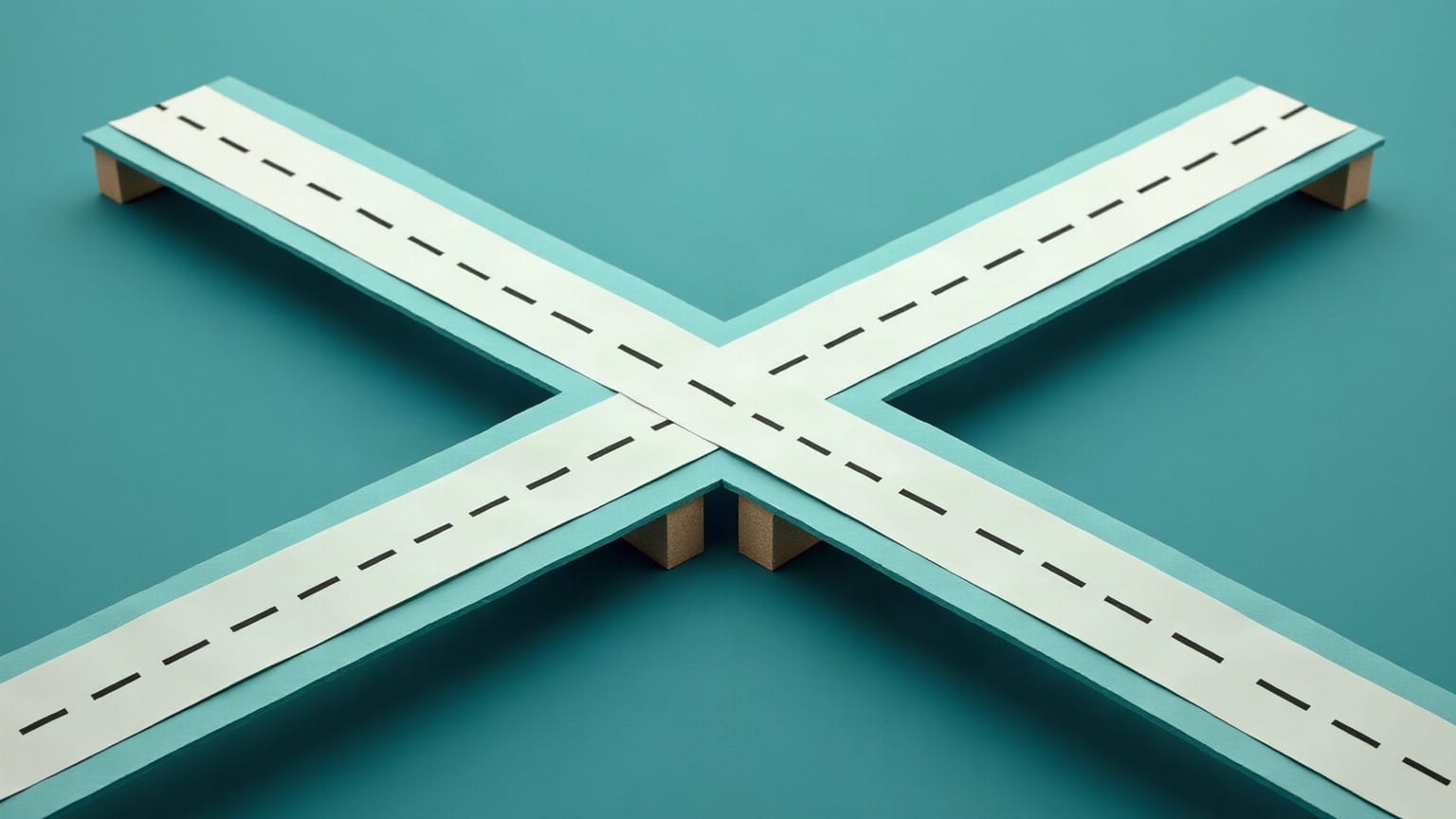 Two chalk-white paper roads with dashed lane markings crossing diagonally on a teal ground, one carried over the other on small sand-coloured piers